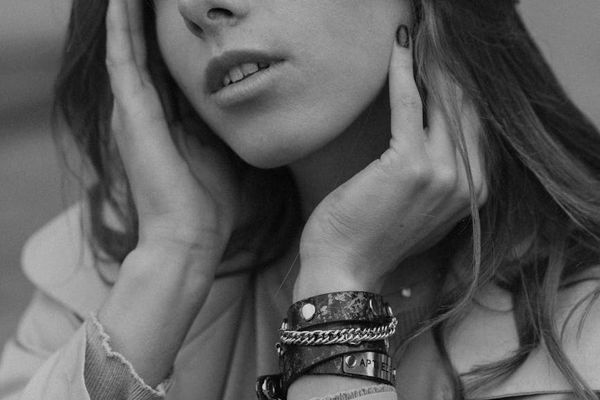 Person relaxing with closed eyes in a peaceful environment.